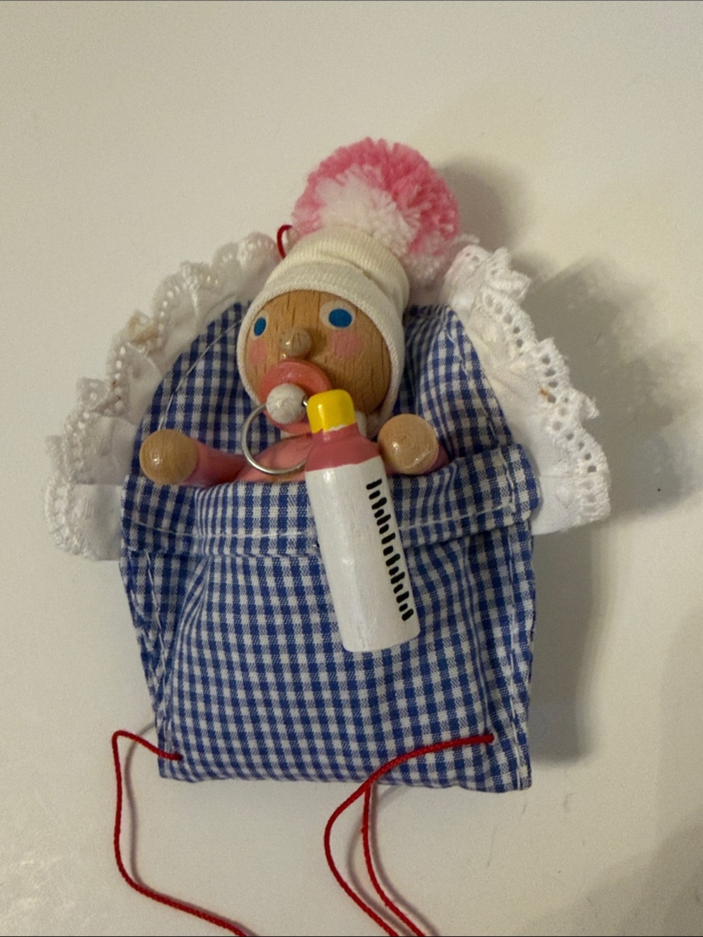 STEINBACH German Baby girl Ornament with bottle, pacifier & Blue Gingham Blanket